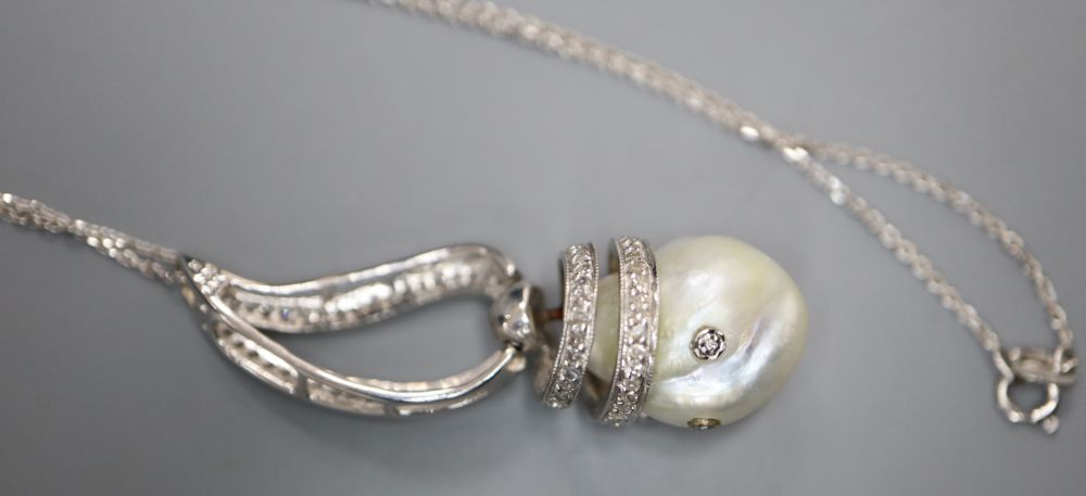 A modern 14k white metal, baroque pearl and diamond set drop pendant, on 750 white metal chain, pendant, 43mm, gross 8.5 grams.